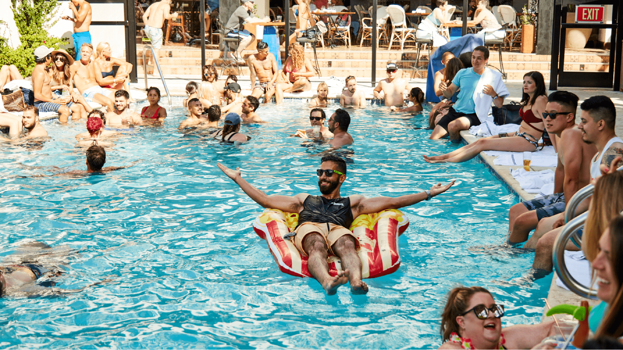Partygoers hang out in a pool