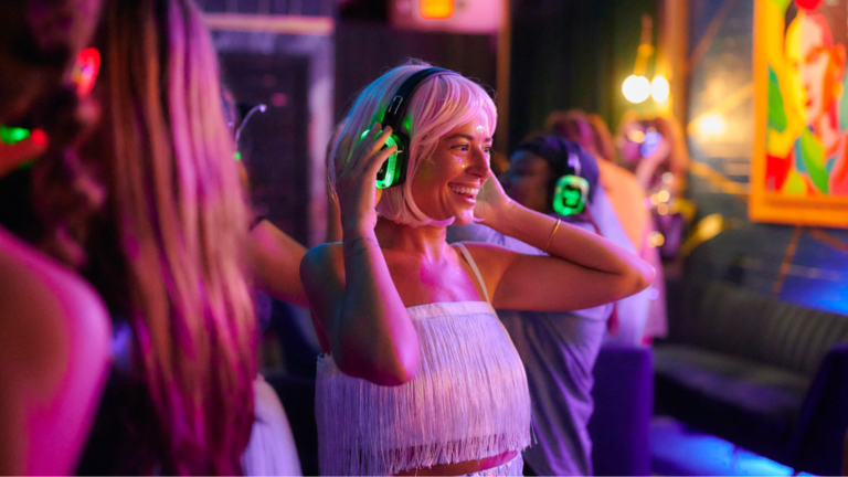 Guest puts on headphones at silent disco