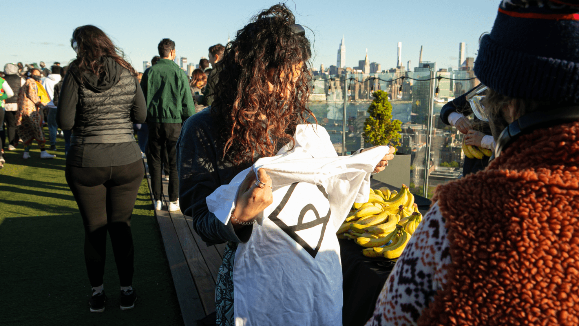 A person holding up event merchandise