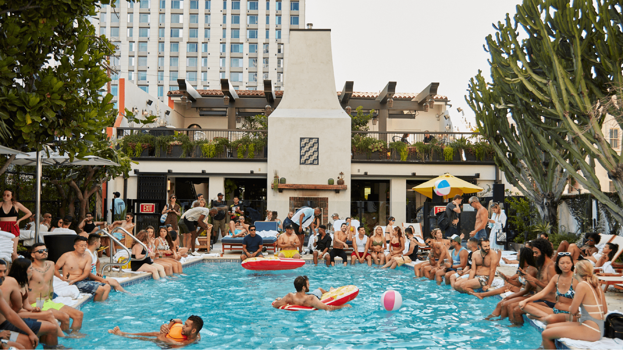 Pool party guests chat at a pool