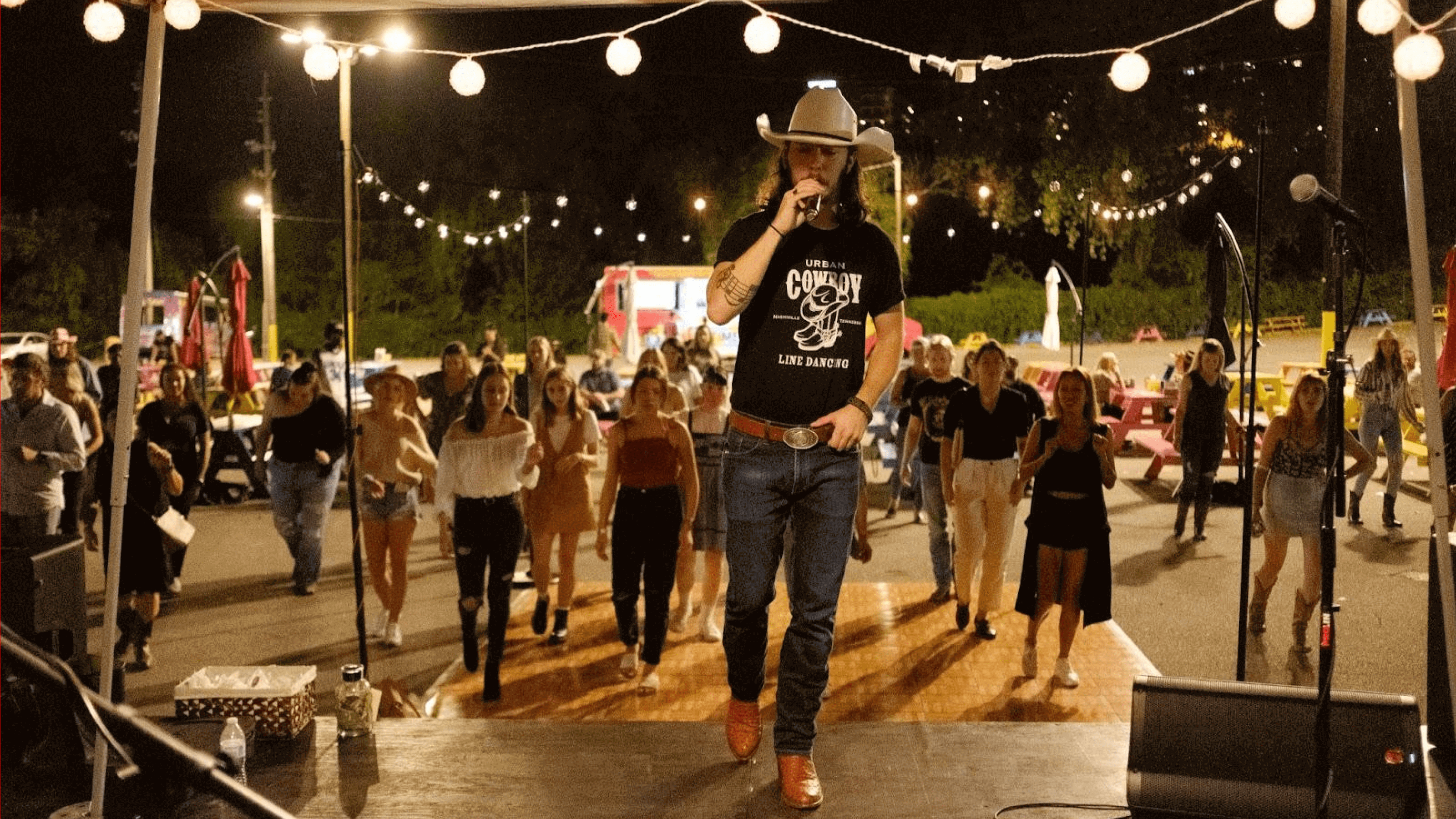 People learning how to country dance at an experiential marketing event