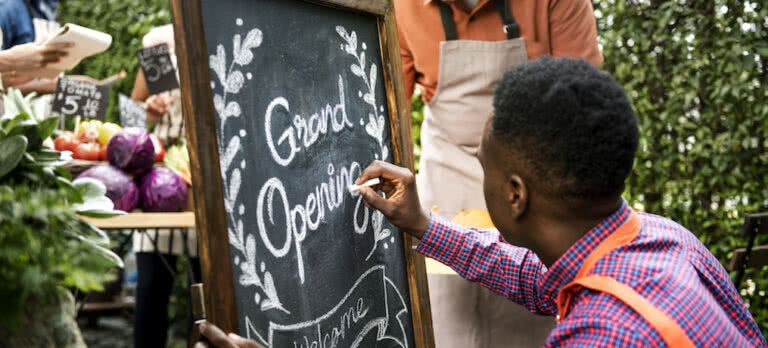 man writing on chalkboard