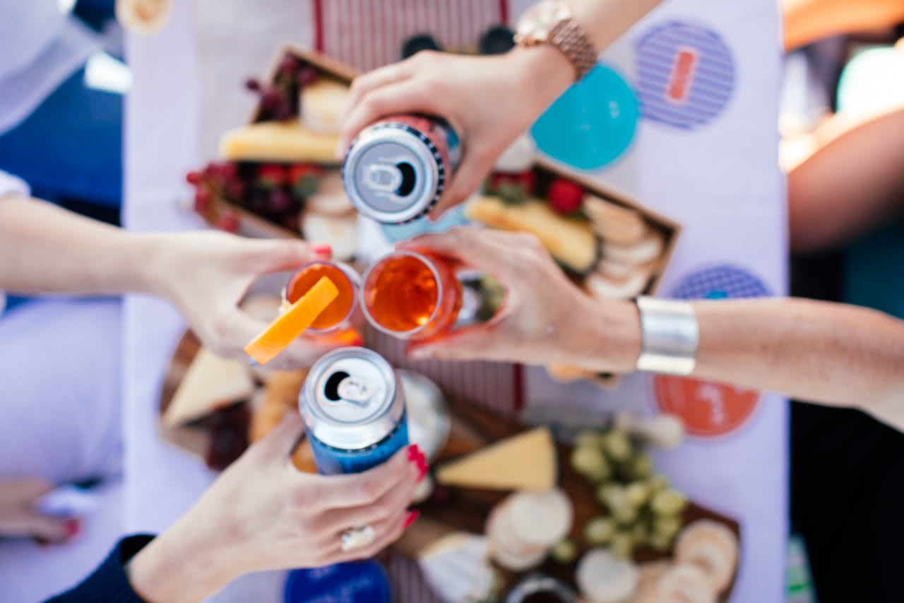 An image of people making a toast over a festive table.