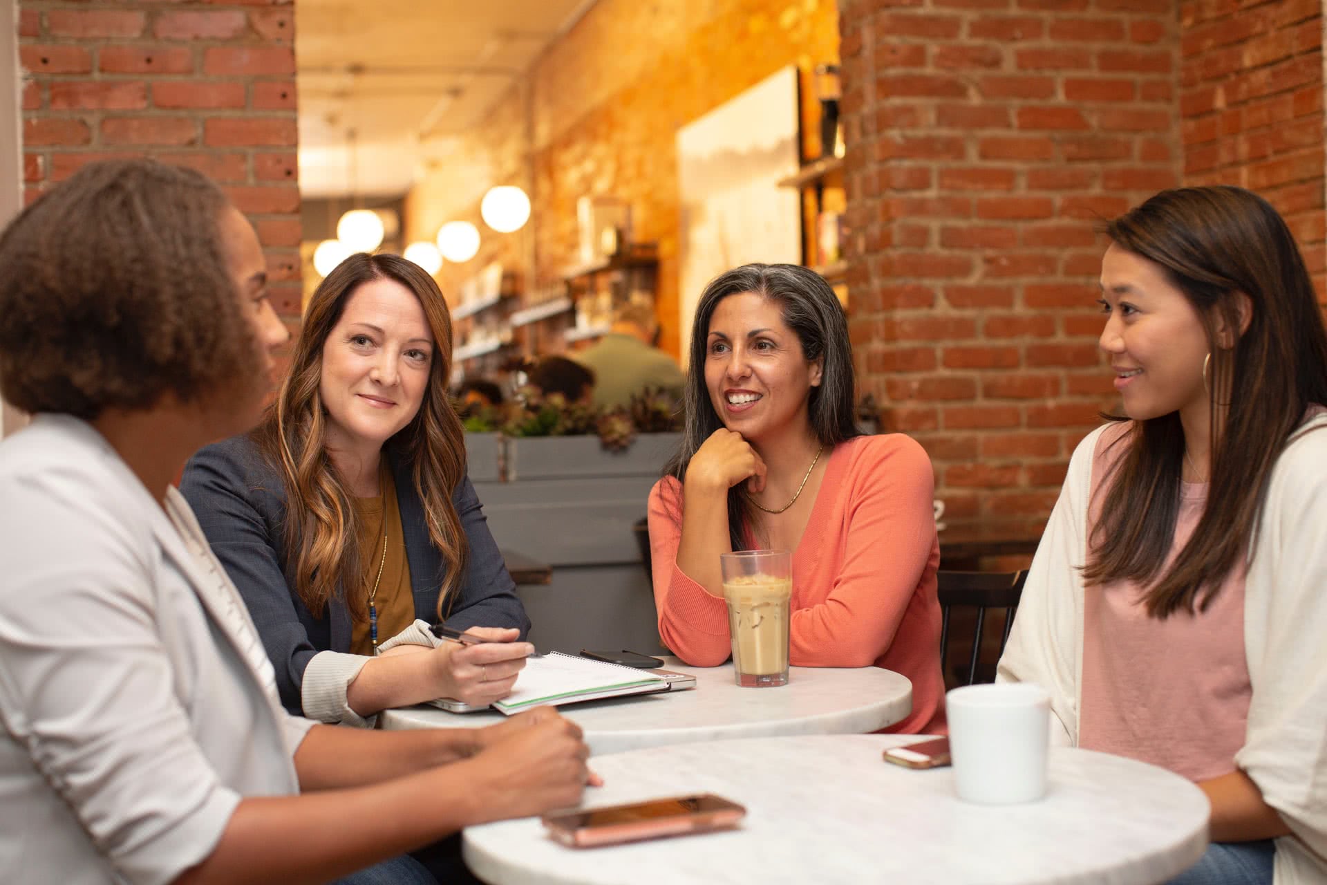 An image of a group of women gathered around a table.