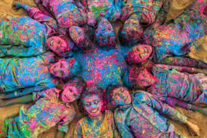 Group of children covered in colored paint