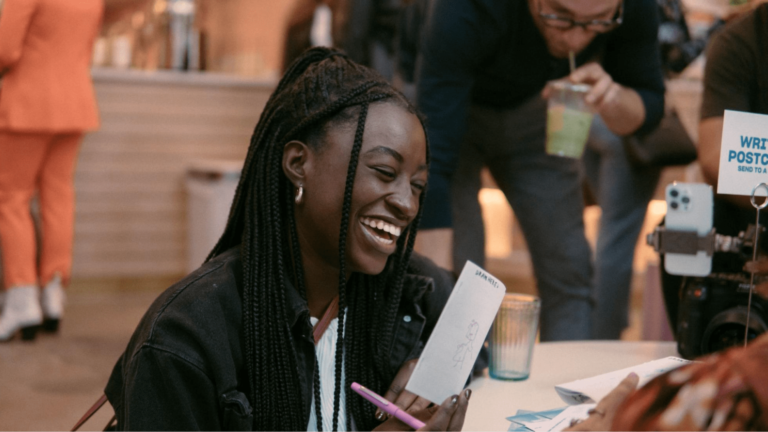 Woman smiles sitting at table