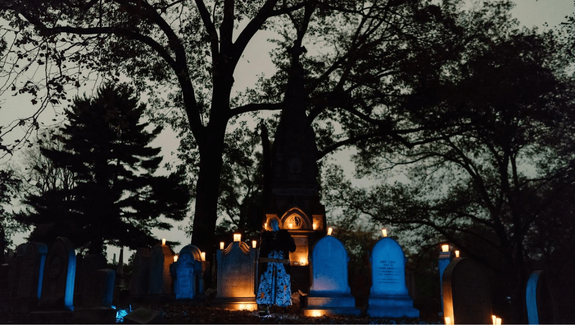 A performer speaks at graveyard event