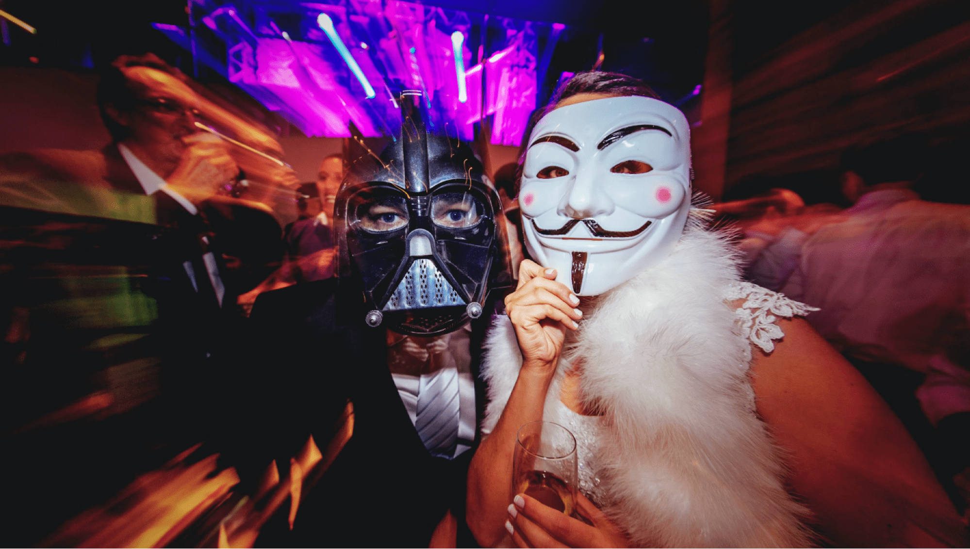 Two costumed party guests pose on dance floor