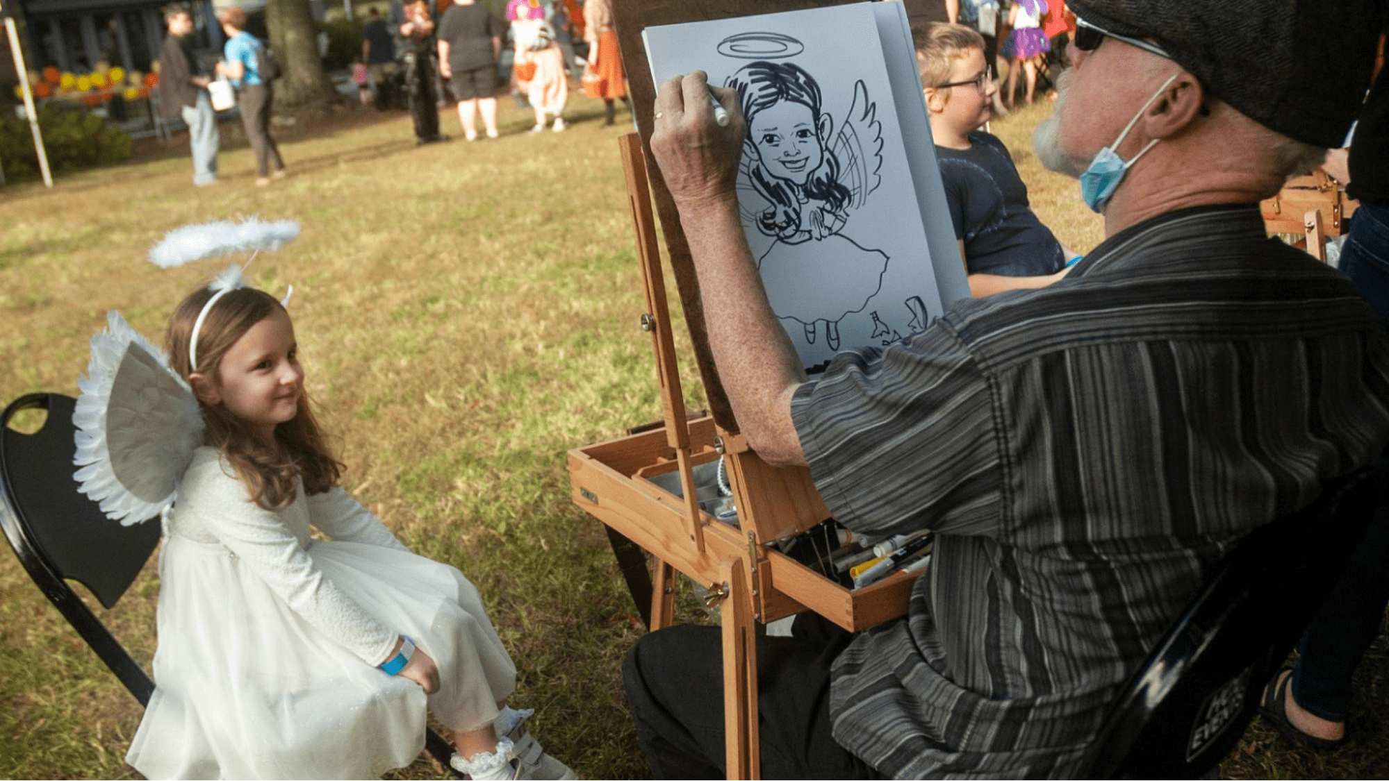 A caricature artist at a fall festival