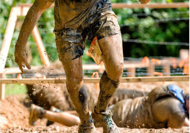 Person doing muddy obstacle course