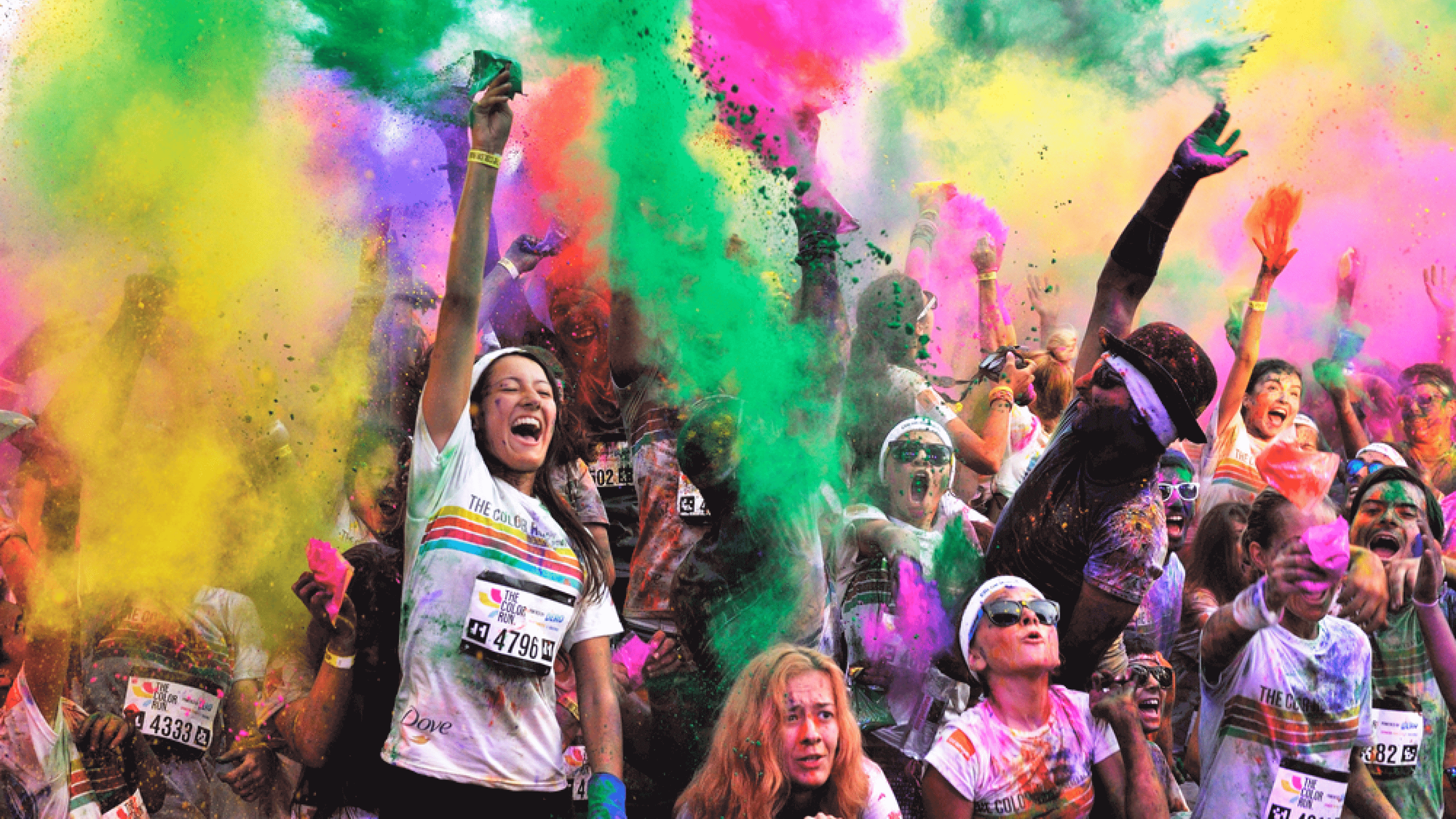 Runners celebrate completing a color run