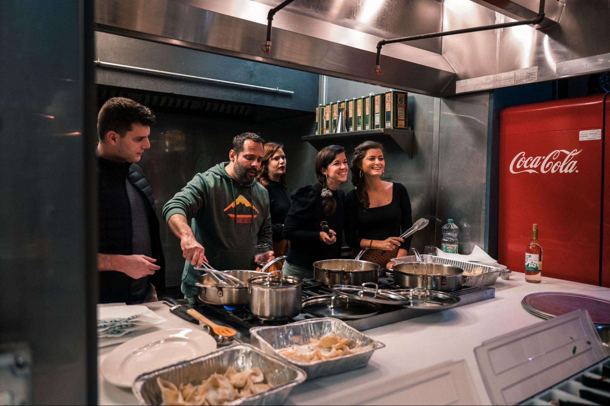 Five people cooking in a class