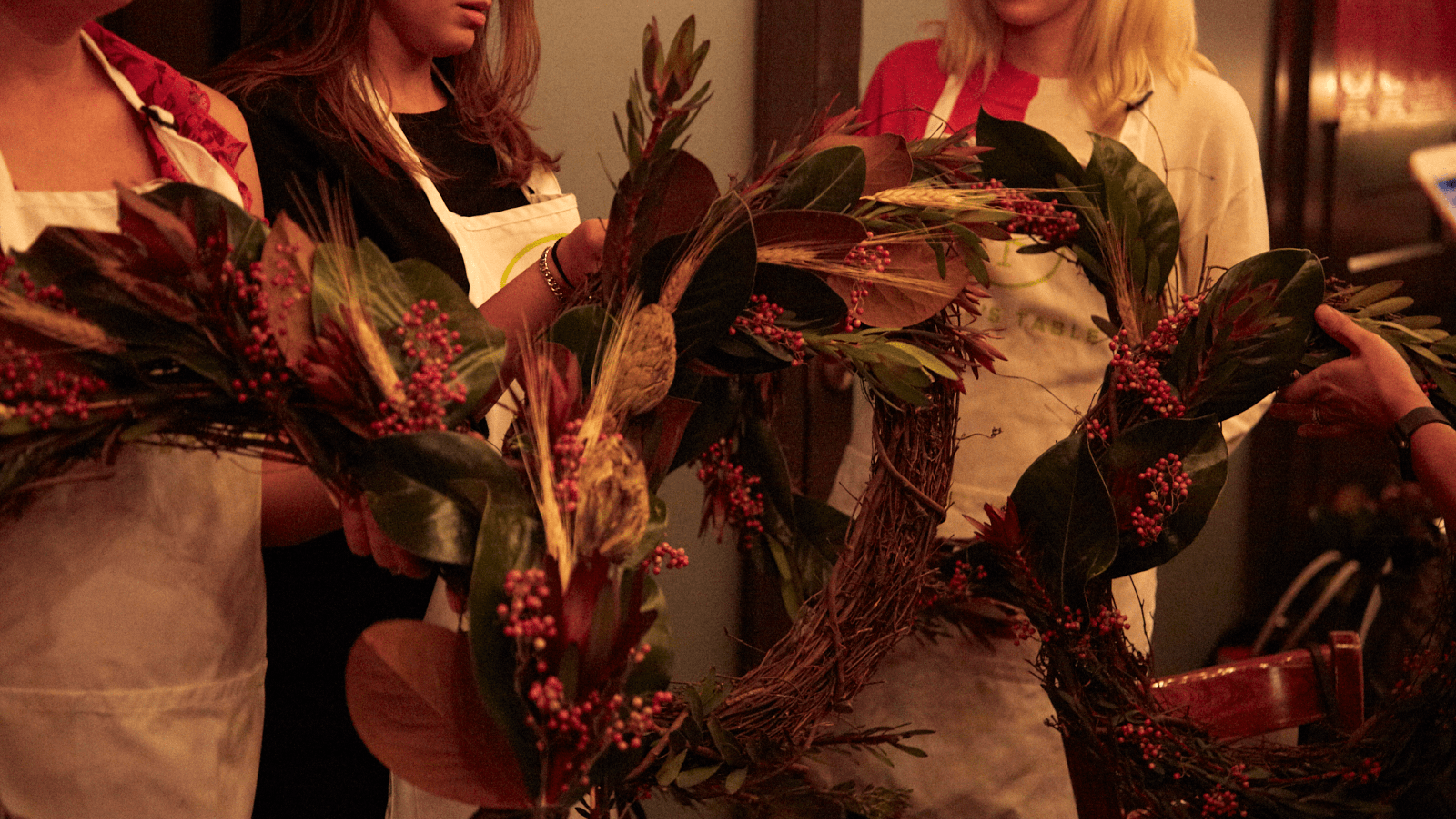 People making wreaths at a holiday party