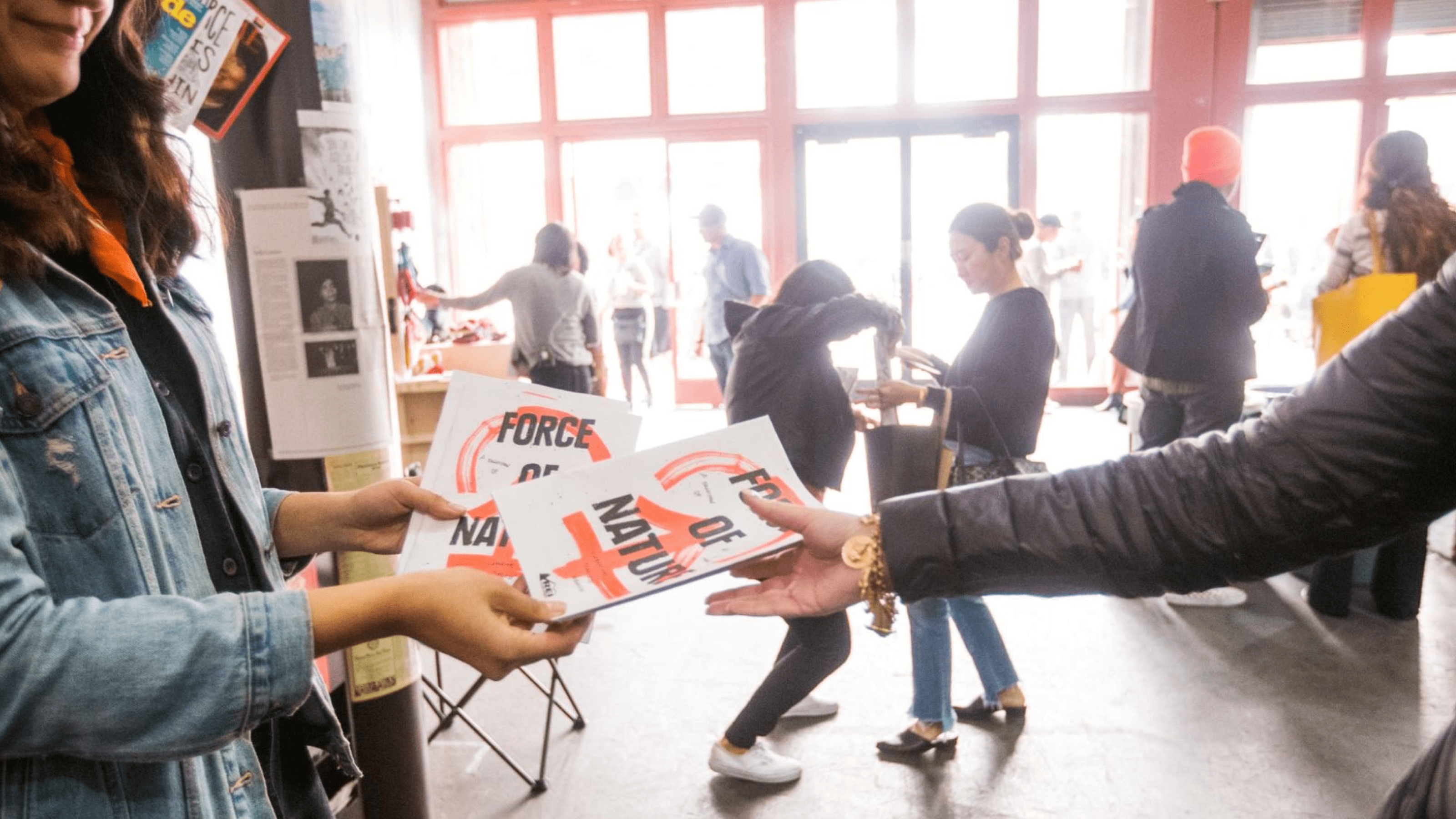 Person handing out flyers at a conference