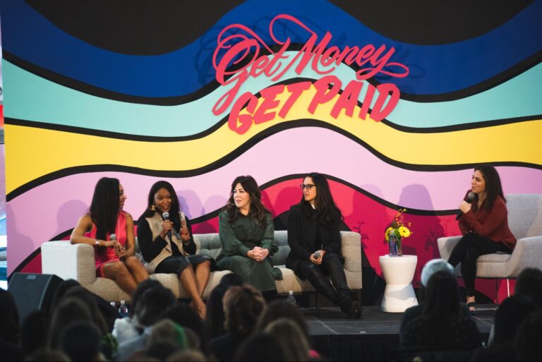 A panel of women at a conference