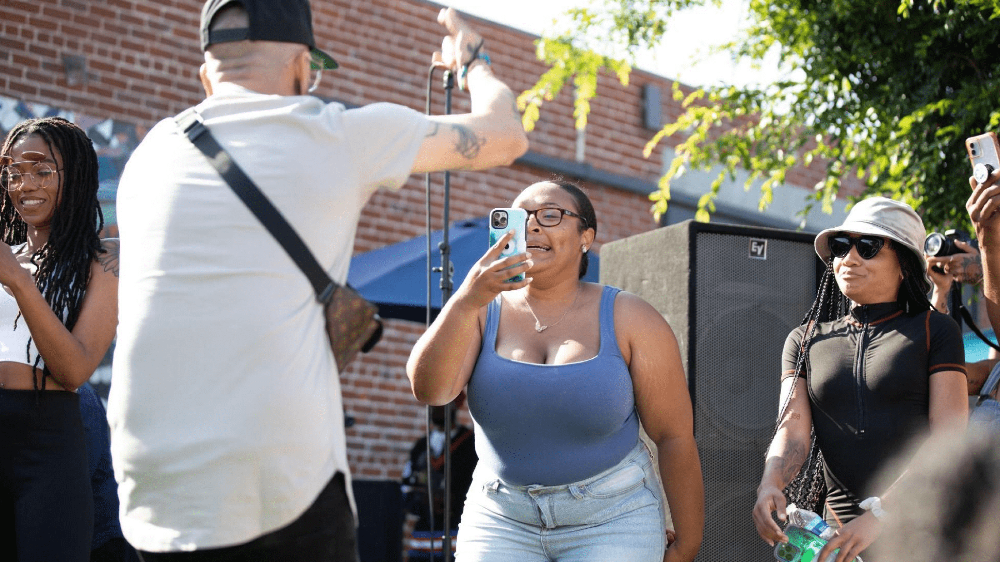 Woman taking photo of singer with her phone