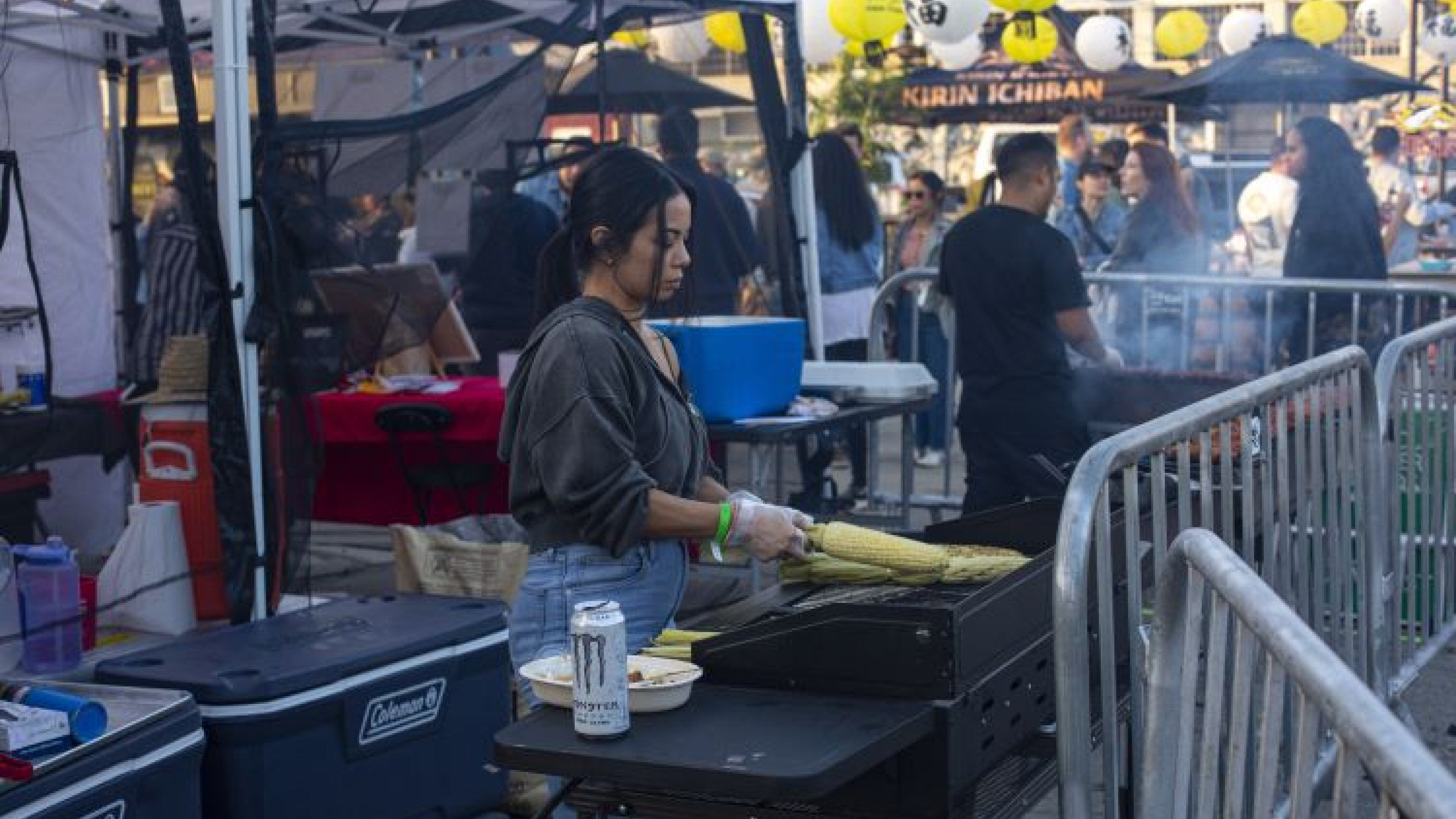 Woman grilling corn on the BBQ