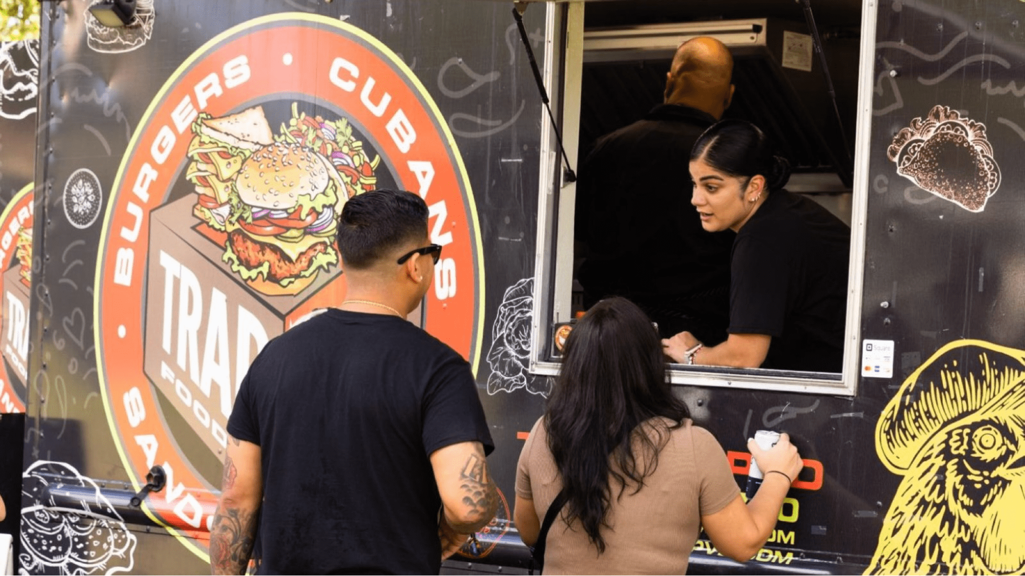 People getting food from a food truck 