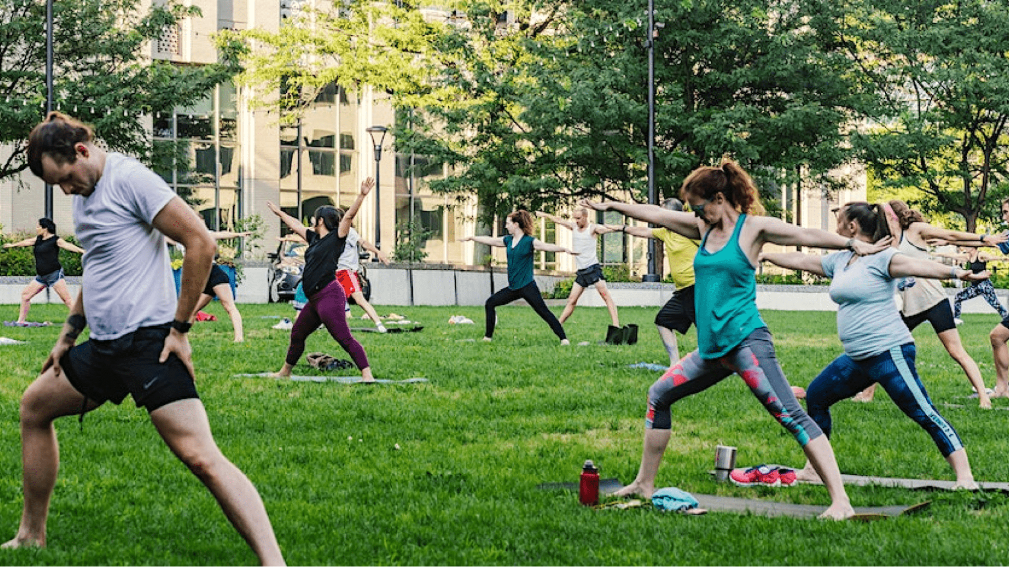 Event attendees practicing yoga in the park