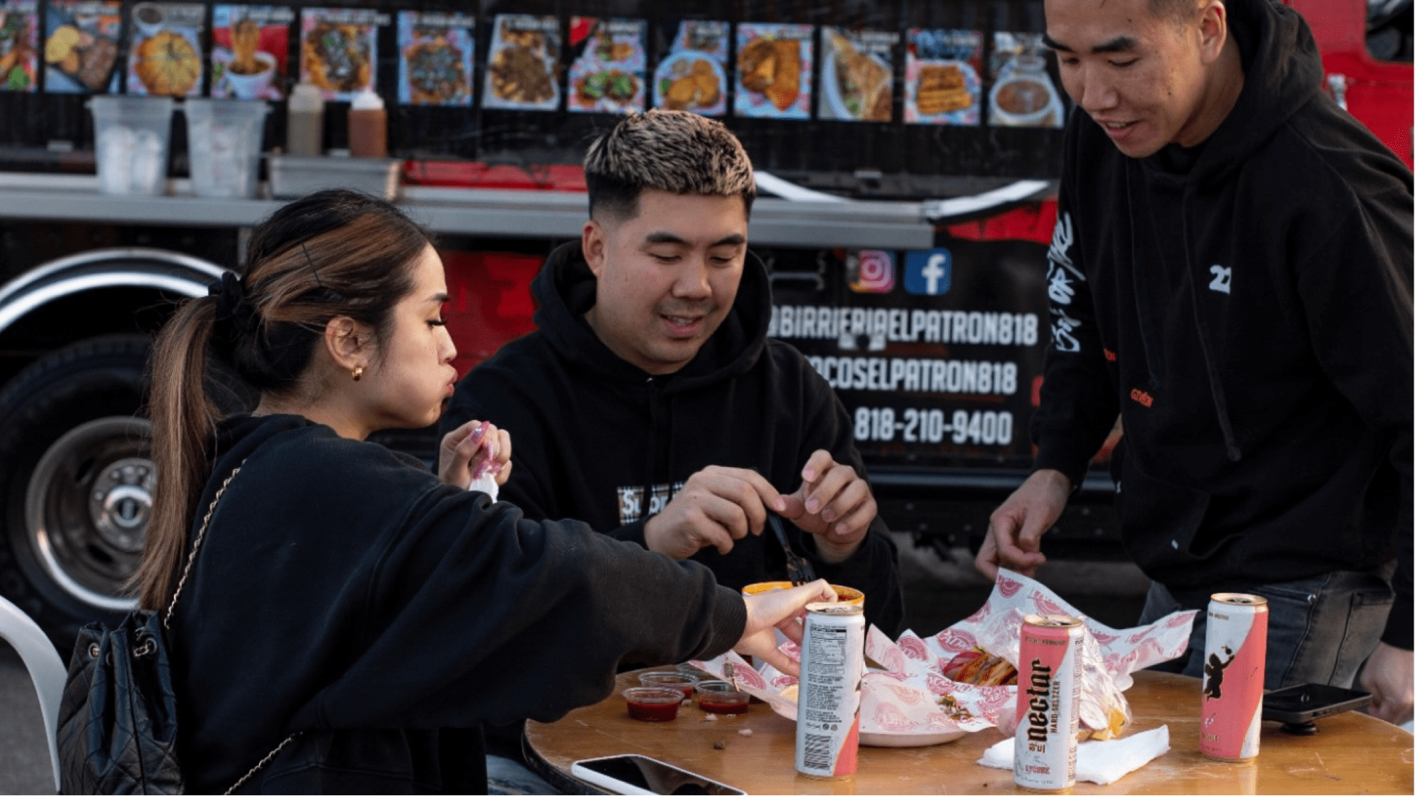 People eating in front of a food truck