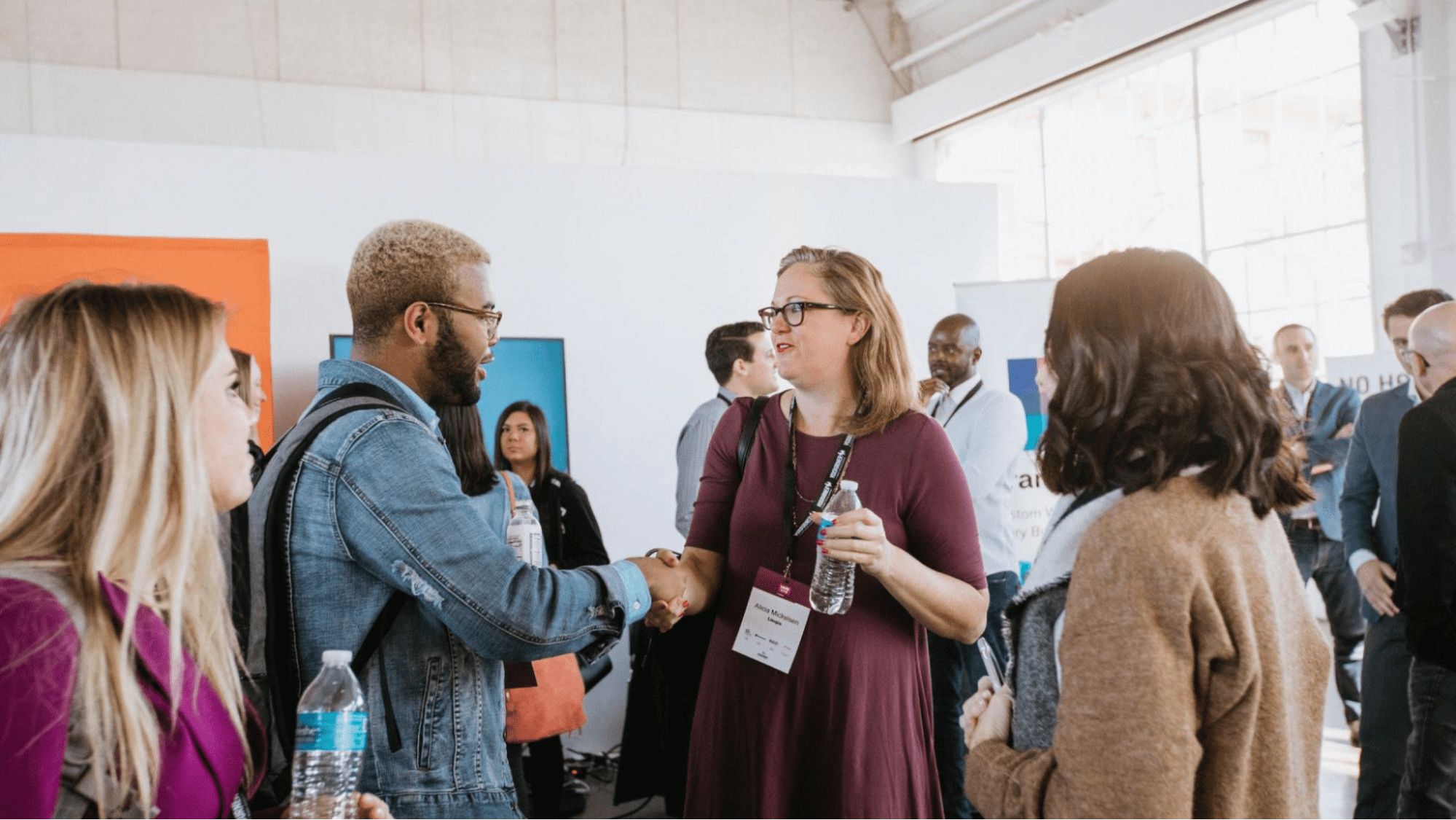 Two people shaking hands at a conference