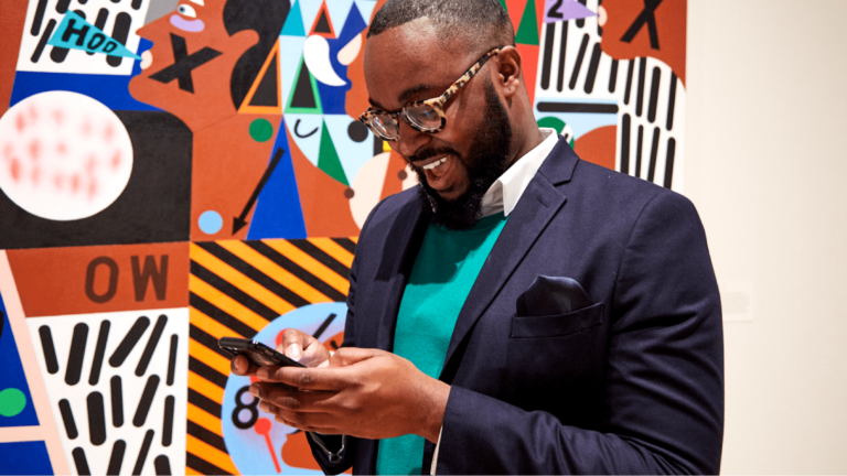 Man looks at phone at CAAM event