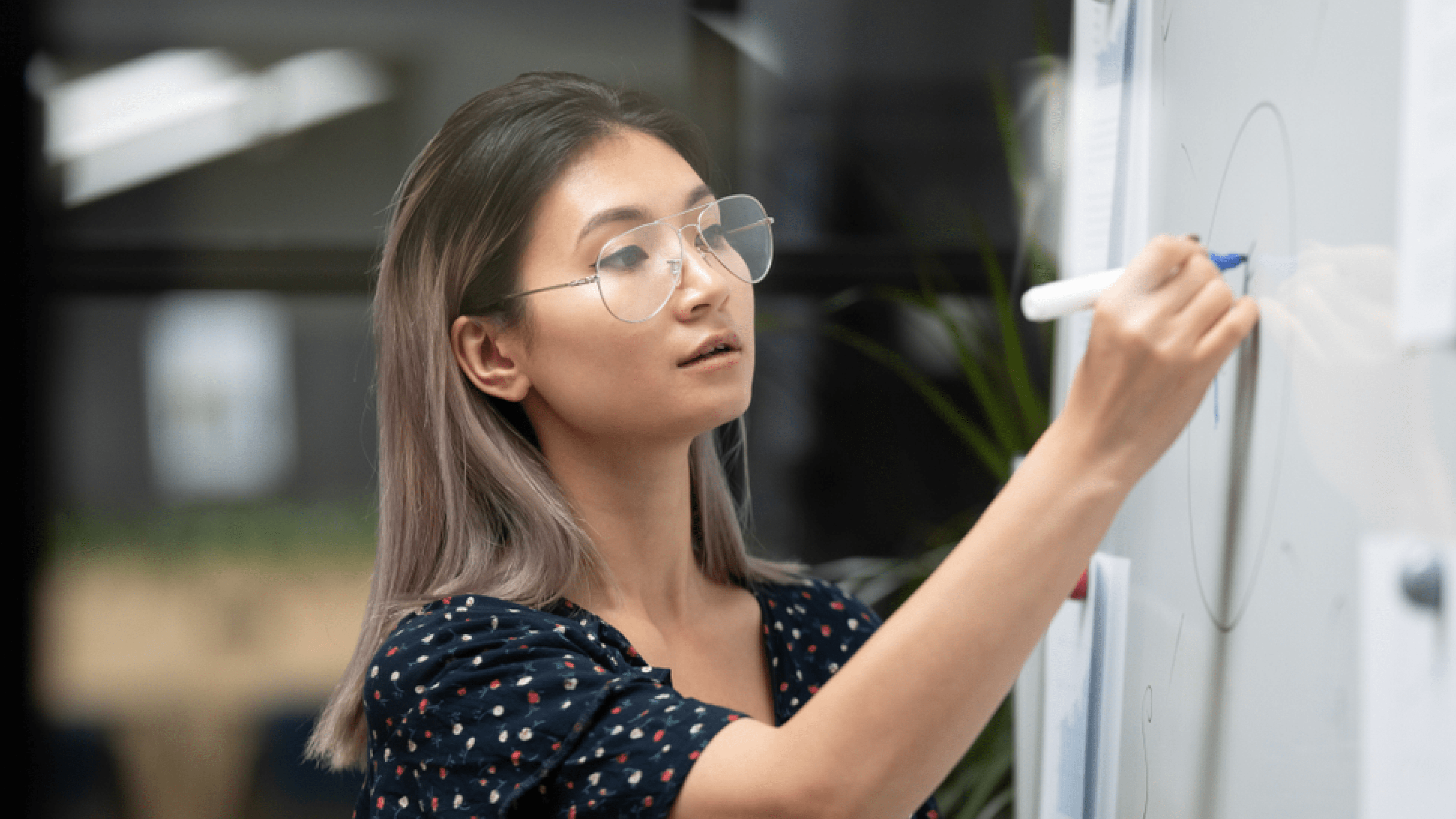 Woman drawing on a whiteboard