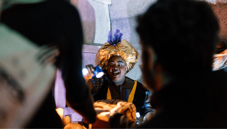 A person in costume spooks Halloween party guests