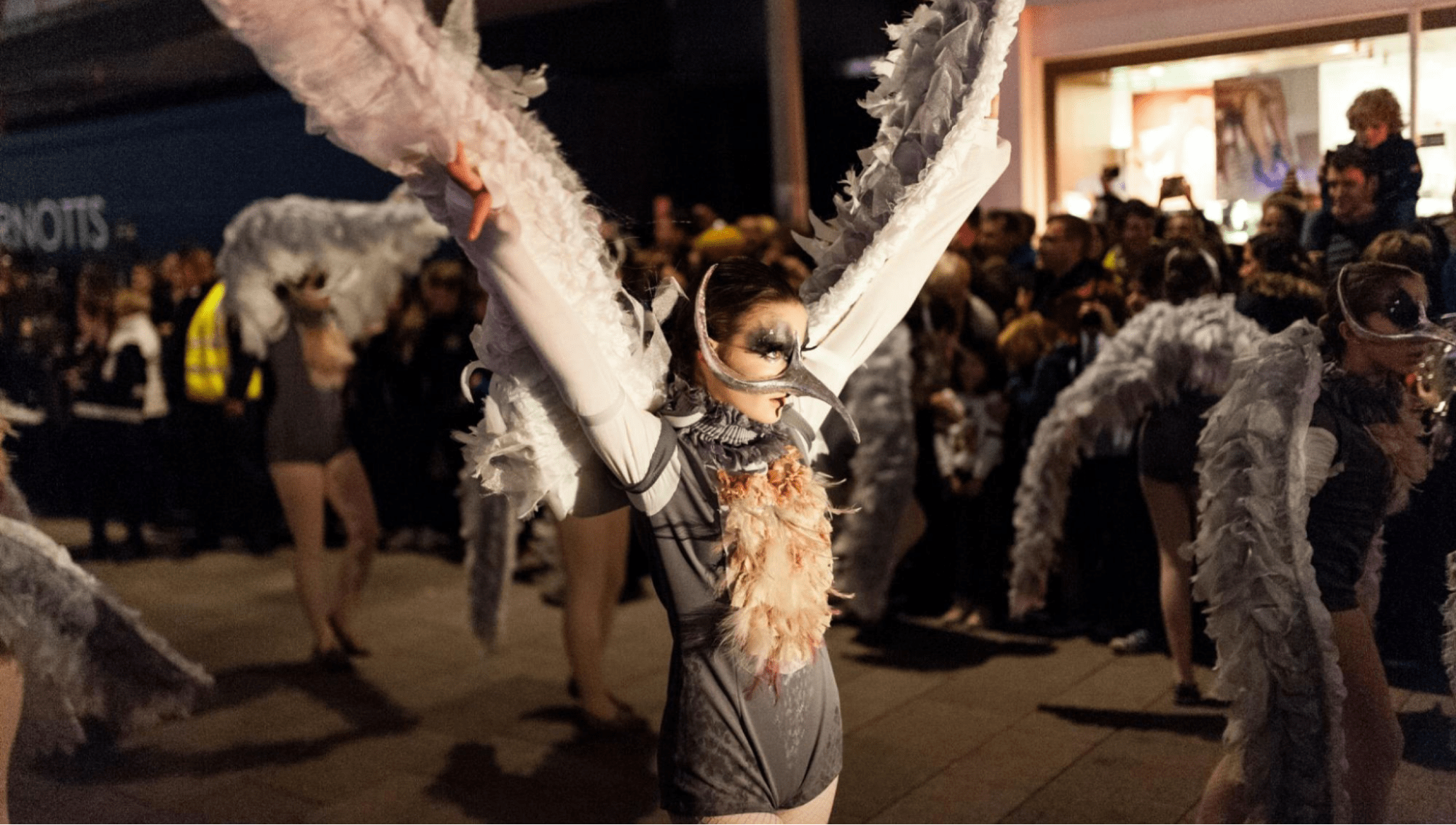 A woman dressed as a bird in a Halloween parade