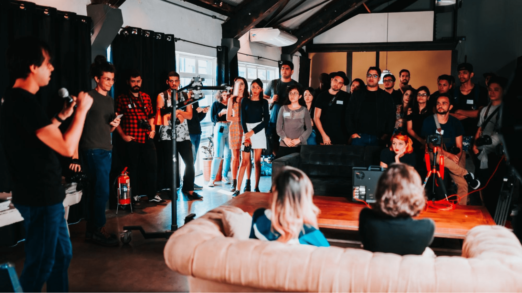 Open mic night with people standing and listening to the speaker