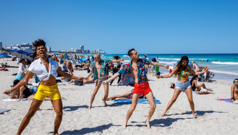 A group of people dancing on the beach