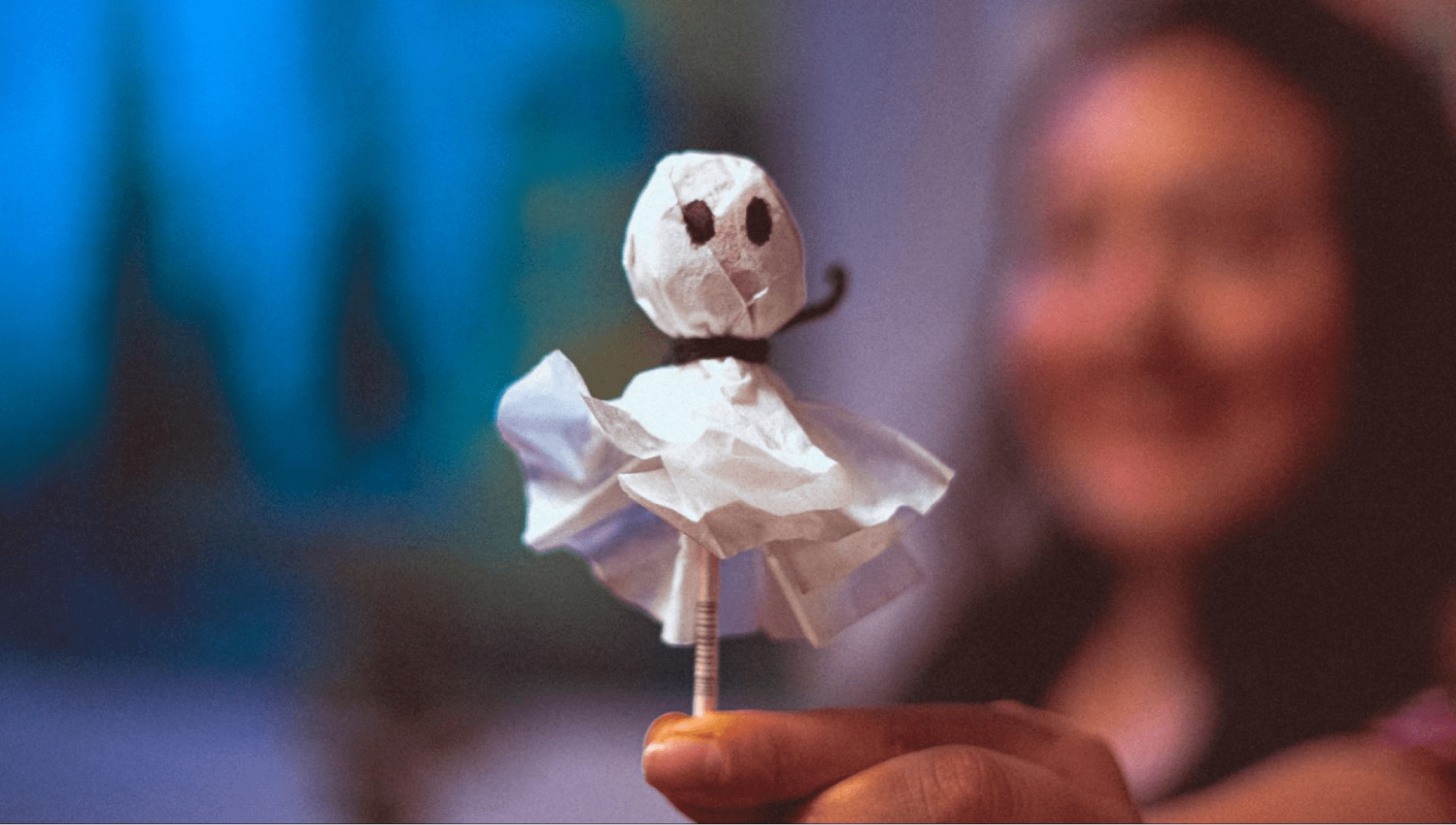 A woman holds a homemade ghost pop
