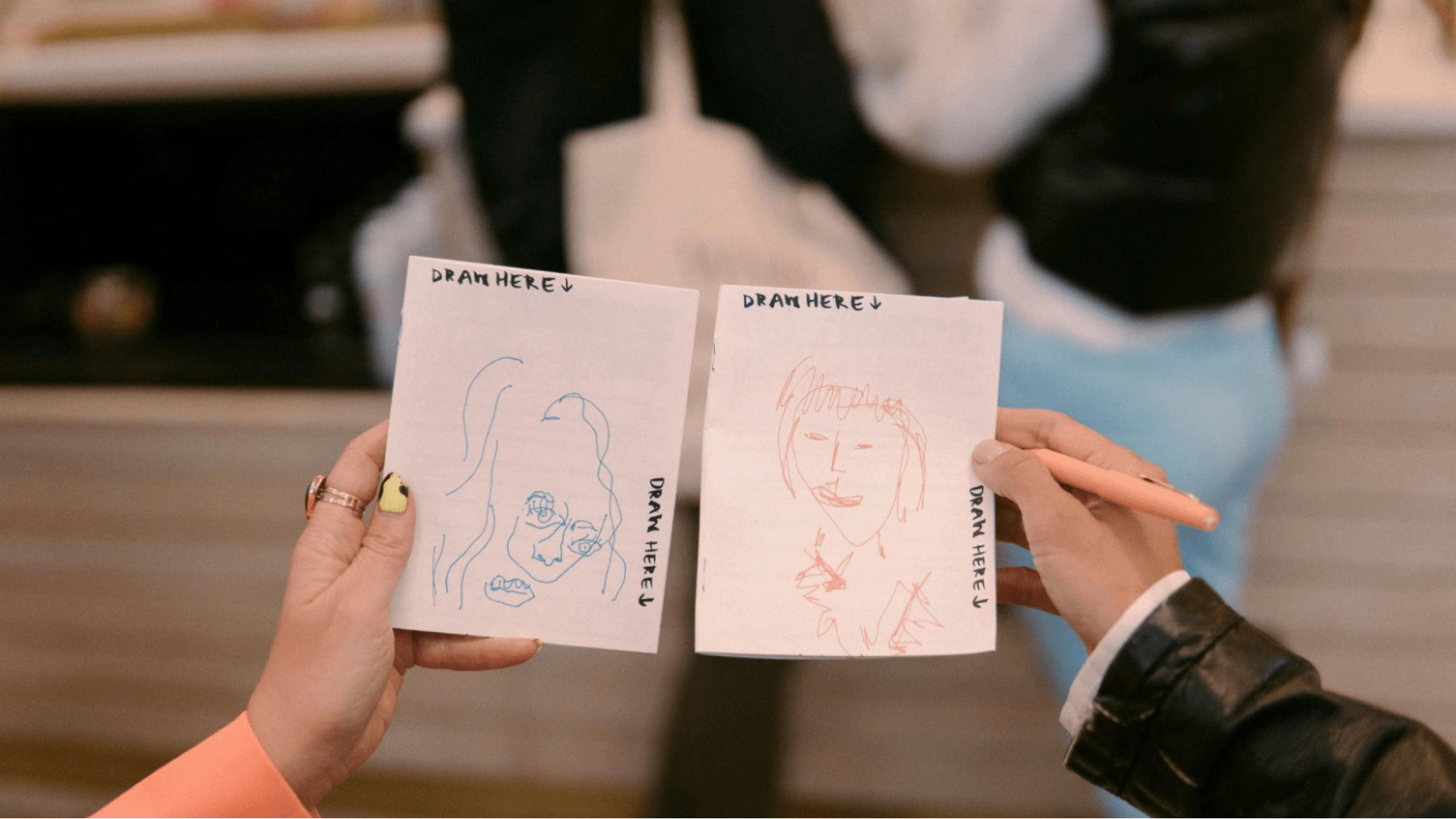 Two blind drawing portraits