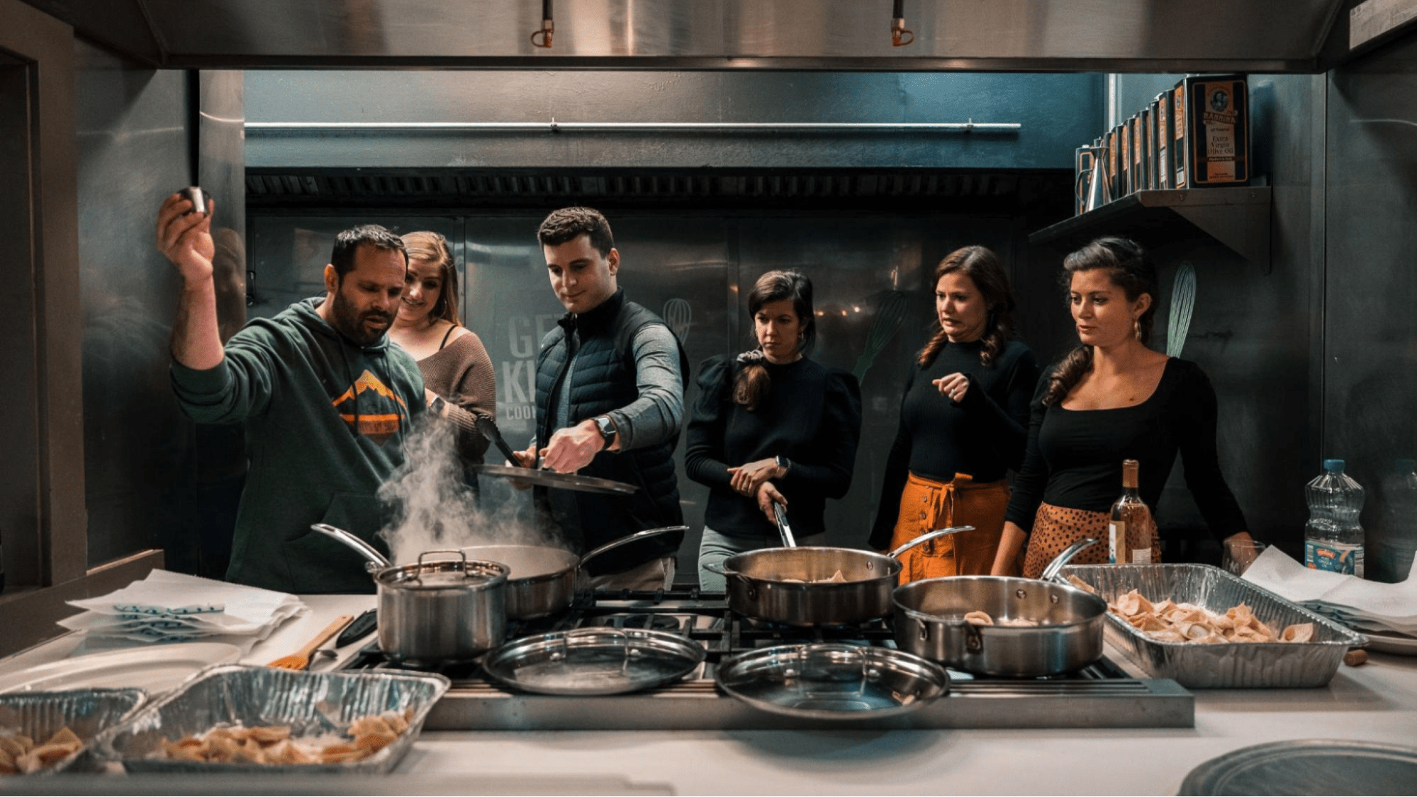 A group of people taking a cooking class