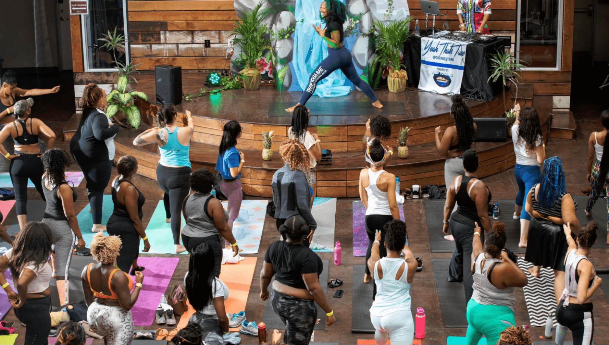 Yoga instructor on stage teaching a class