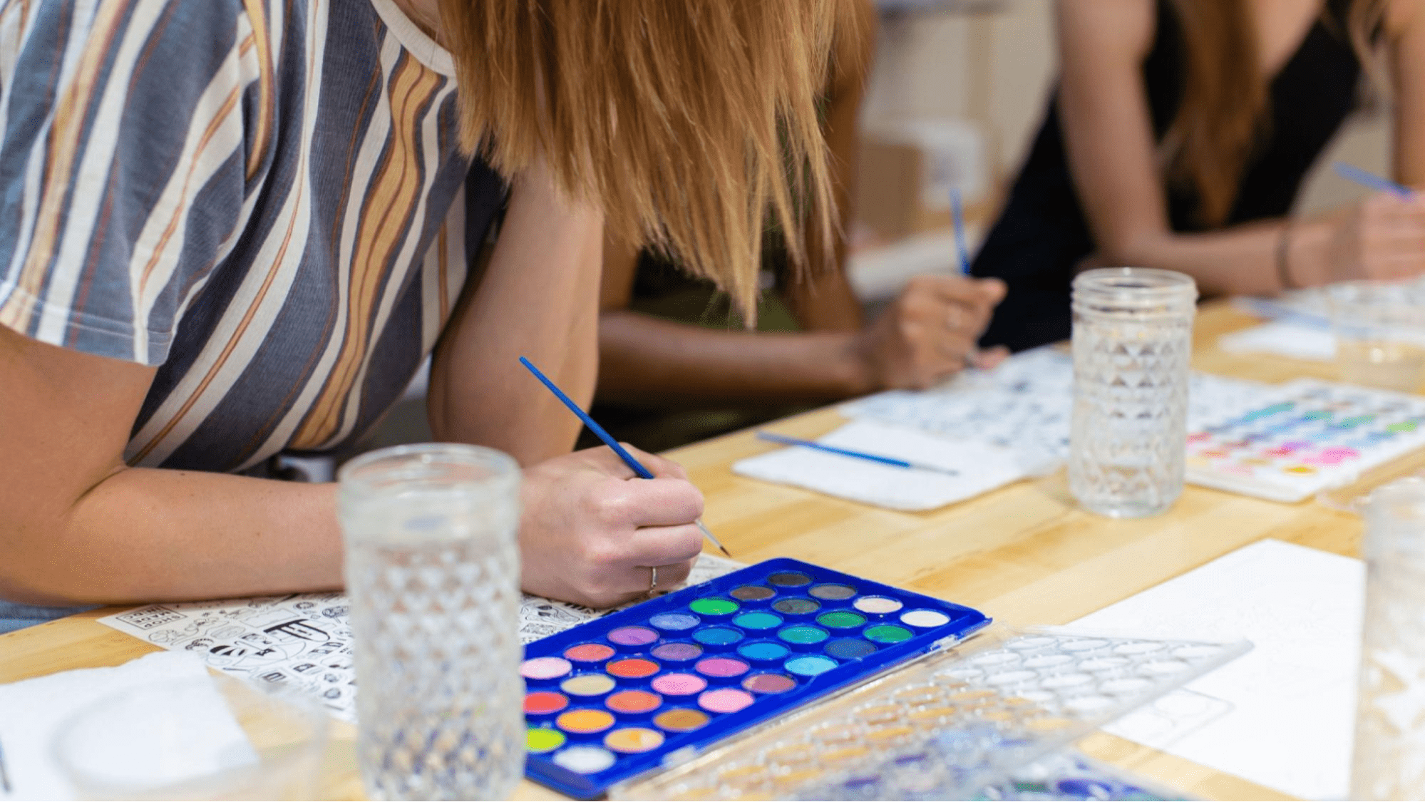 attendees painting at a workshop
