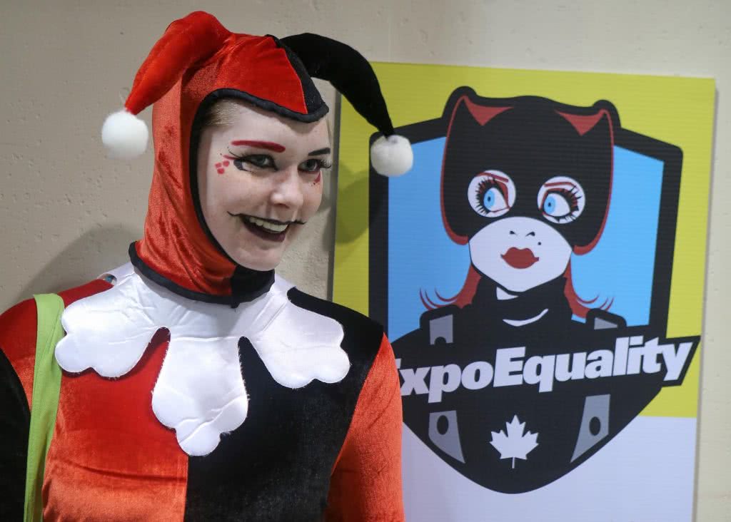 Cosplayer poses against comic con harassment sign about consent